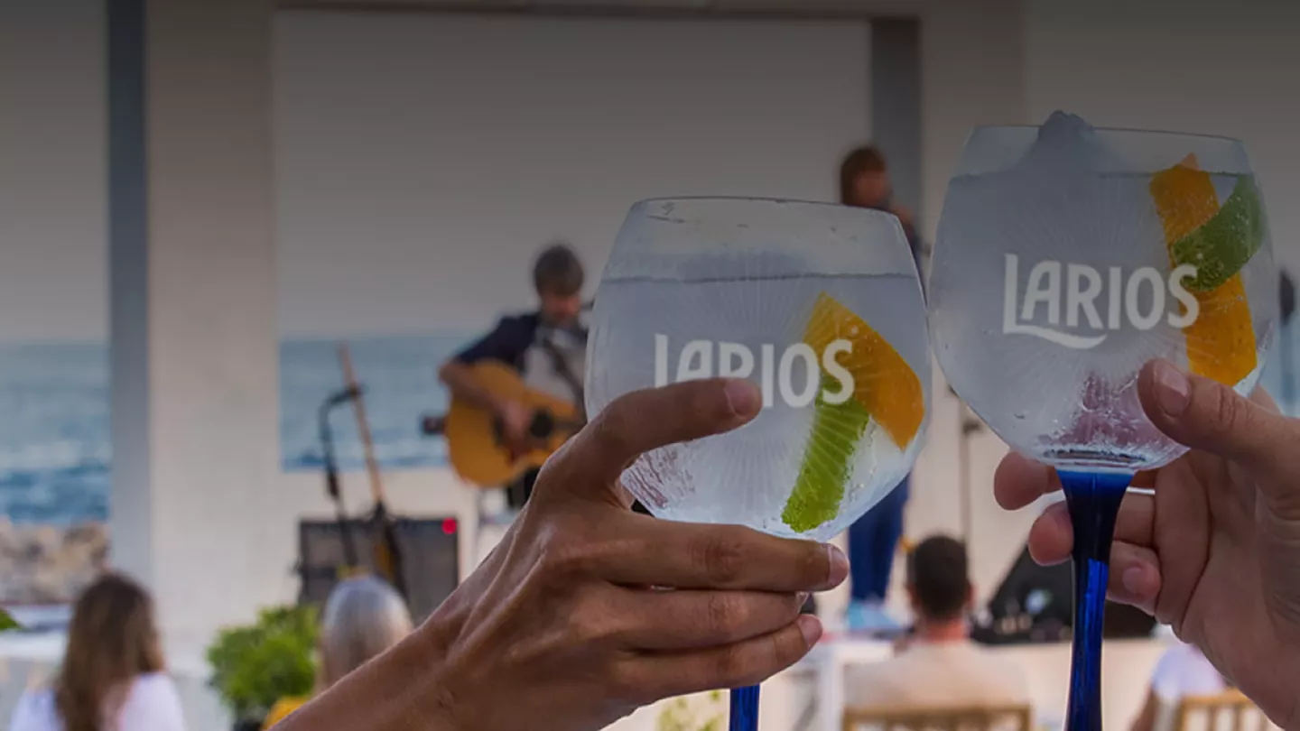 Two glasses of Larios gin at a live music show