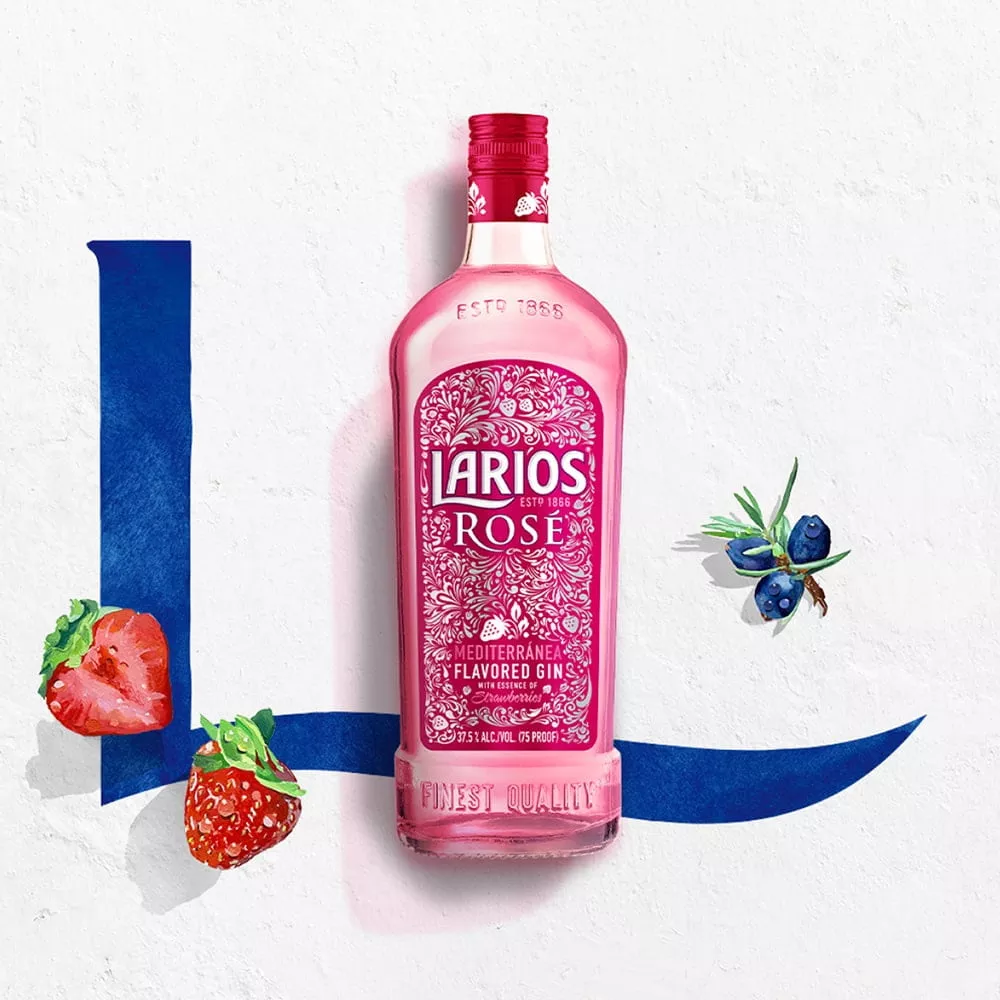 Bottle of Larios rose between strawberries and juniper berries 
