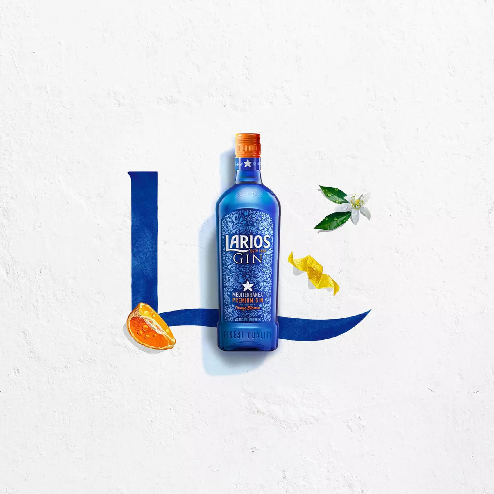 Bottle of Larios dry gin beside a fresh cut of orange