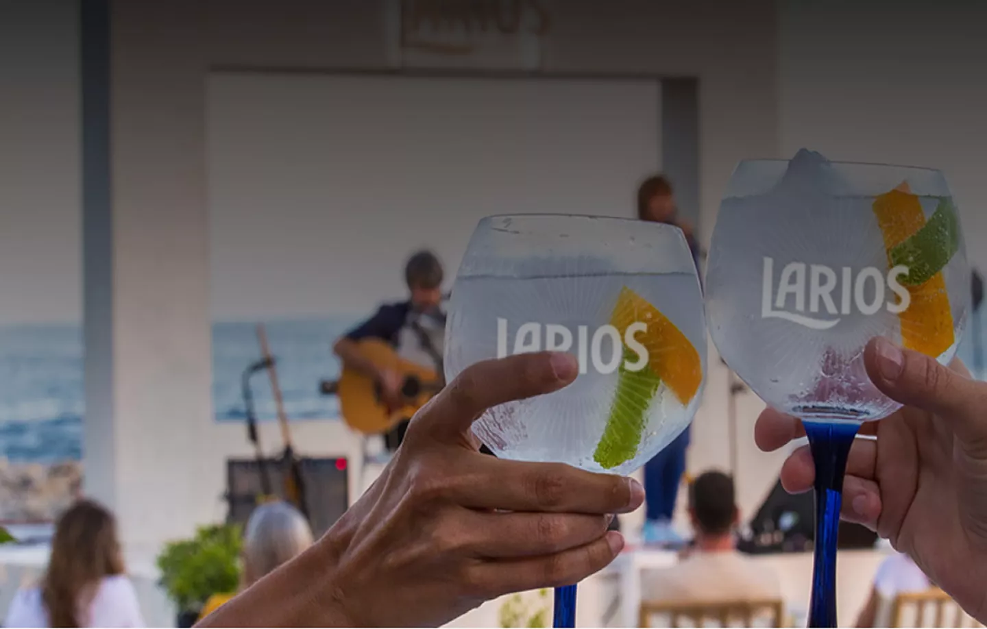 Two glasses of Larios gin at a live music show