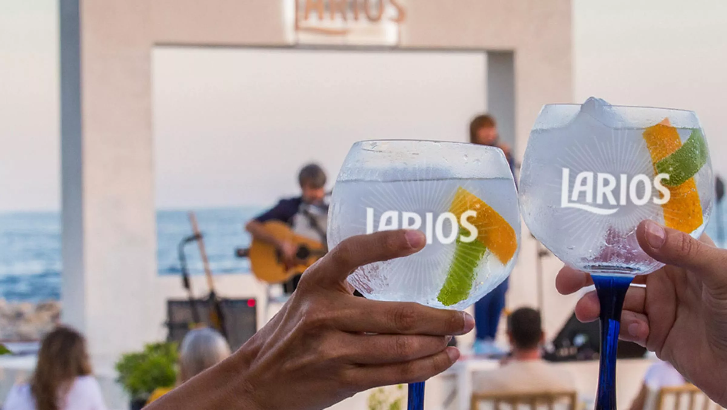 Two glasses of Larios gin at a live music show.